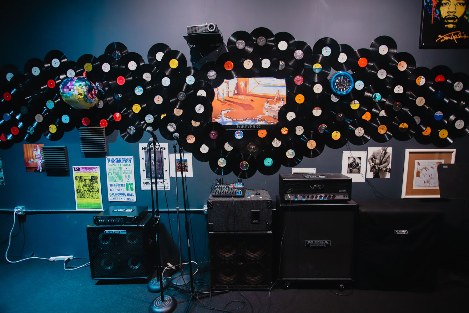 Studio wall of vinyl records and amps